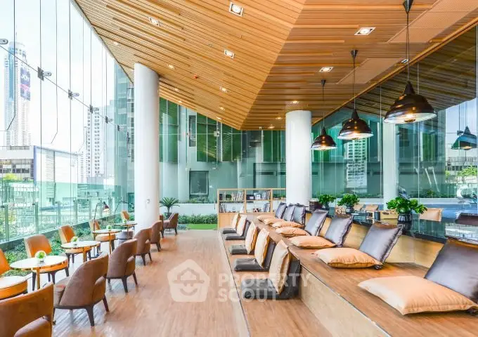 Modern co-working space with stylish seating and city views, perfect for productivity and networking.