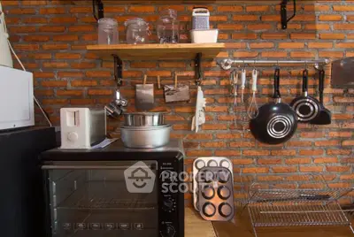 Charming kitchen with brick wall, modern appliances, and open shelving for a cozy, rustic feel.