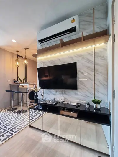 Modern living room with sleek design, featuring wall-mounted TV, stylish lighting, and elegant decor.