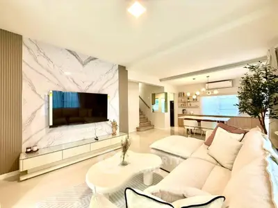 Luxurious open-plan living room with modern decor and elegant lighting