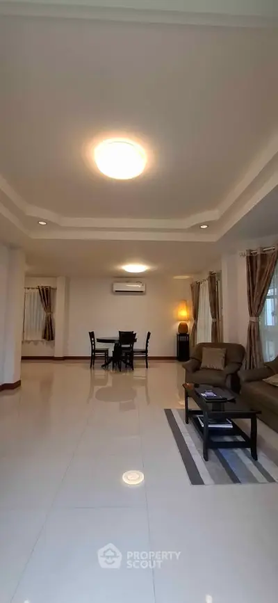 Spacious living room with modern furniture and elegant lighting