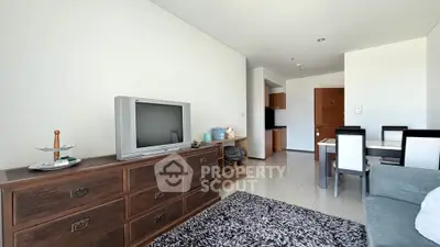 Spacious living room with modern decor and dining area in a stylish apartment.