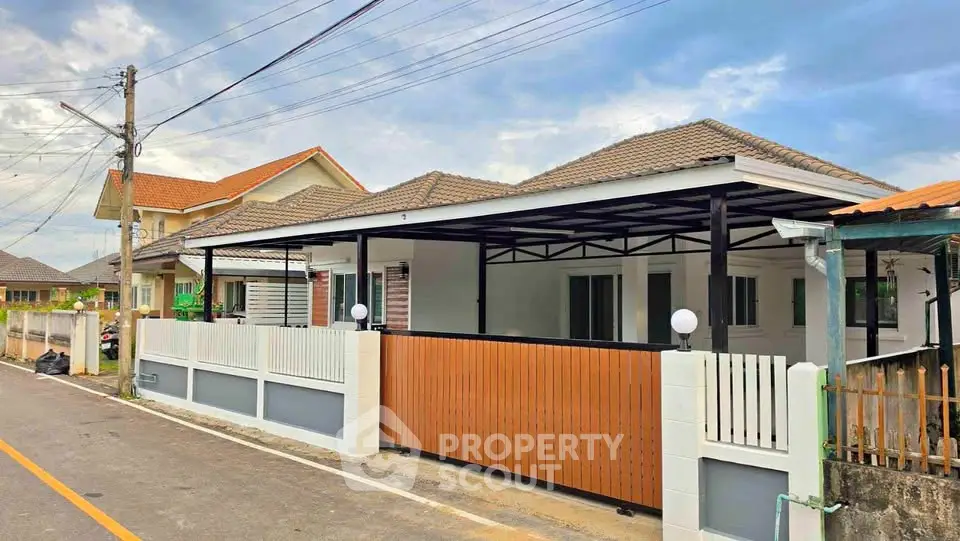 Charming single-story home with modern exterior and spacious carport in a serene neighborhood.