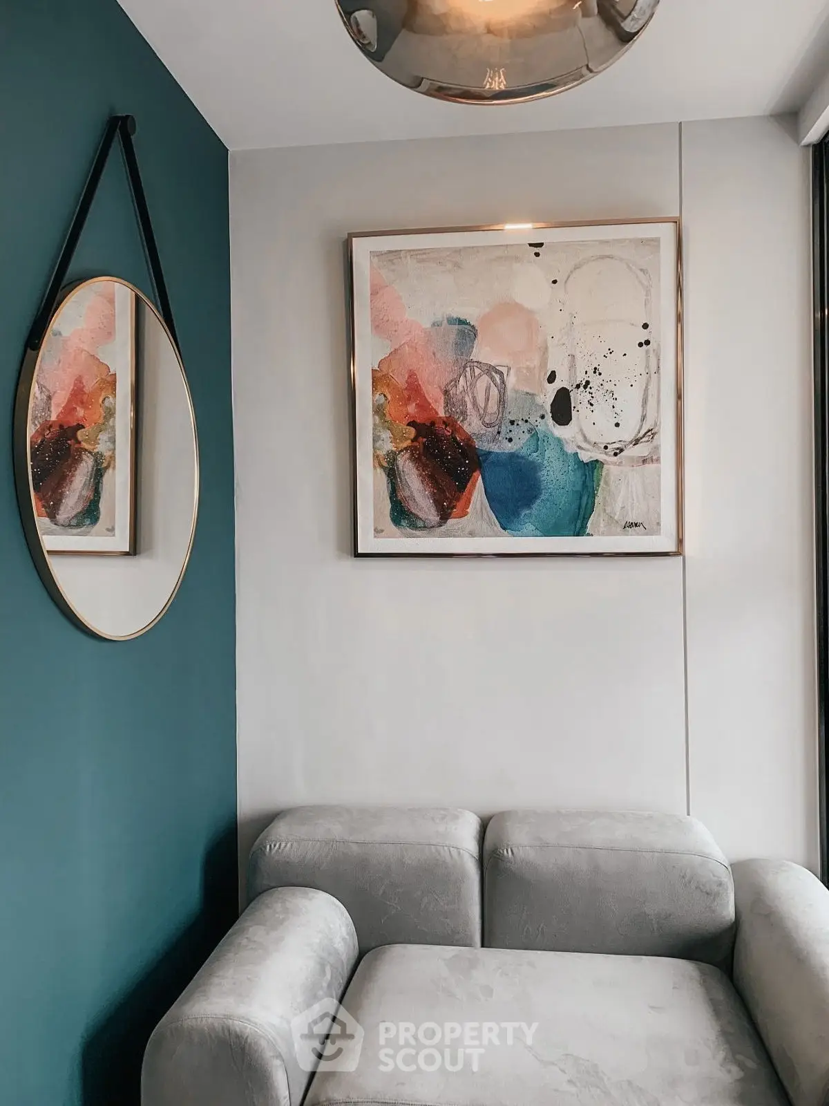 Stylish modern living room corner with abstract art and elegant mirror