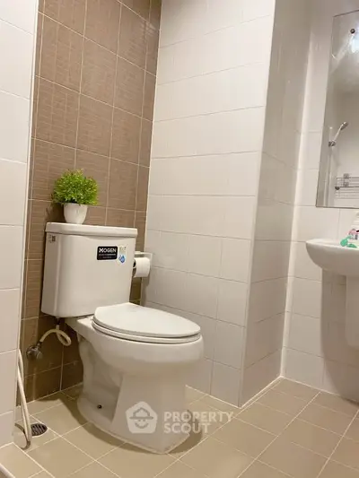 Modern bathroom with sleek white fixtures and stylish tile design.