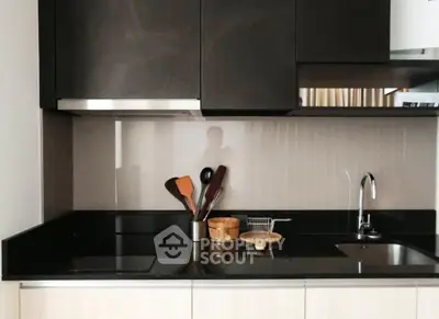 Modern kitchen with sleek black countertops and stylish cabinetry