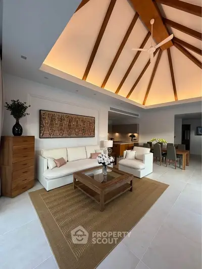 Luxurious living room with high vaulted ceiling and elegant wooden accents