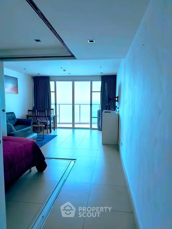 Spacious modern living area with ocean view balcony in luxury apartment