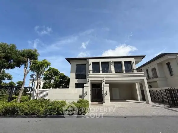 Luxurious modern villa with elegant facade and lush greenery, perfect for upscale living.