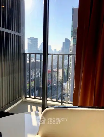 Stunning city view from a modern apartment balcony with sleek glass railing.