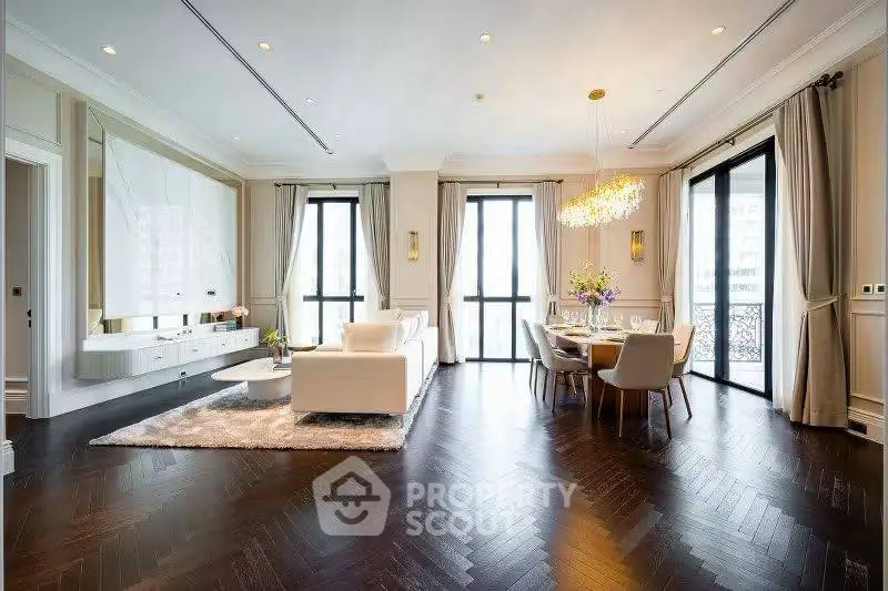 Luxurious open-plan living and dining area with elegant decor and large windows.