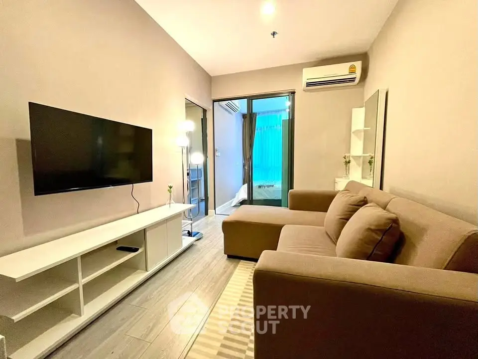 Modern living room with cozy sofa and wall-mounted TV in stylish apartment