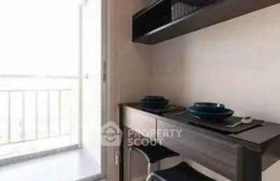 Modern compact kitchen with sleek dining area and balcony access