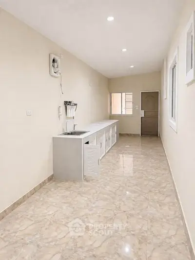 Spacious kitchen with sleek cabinetry and modern finishes, perfect for culinary enthusiasts.