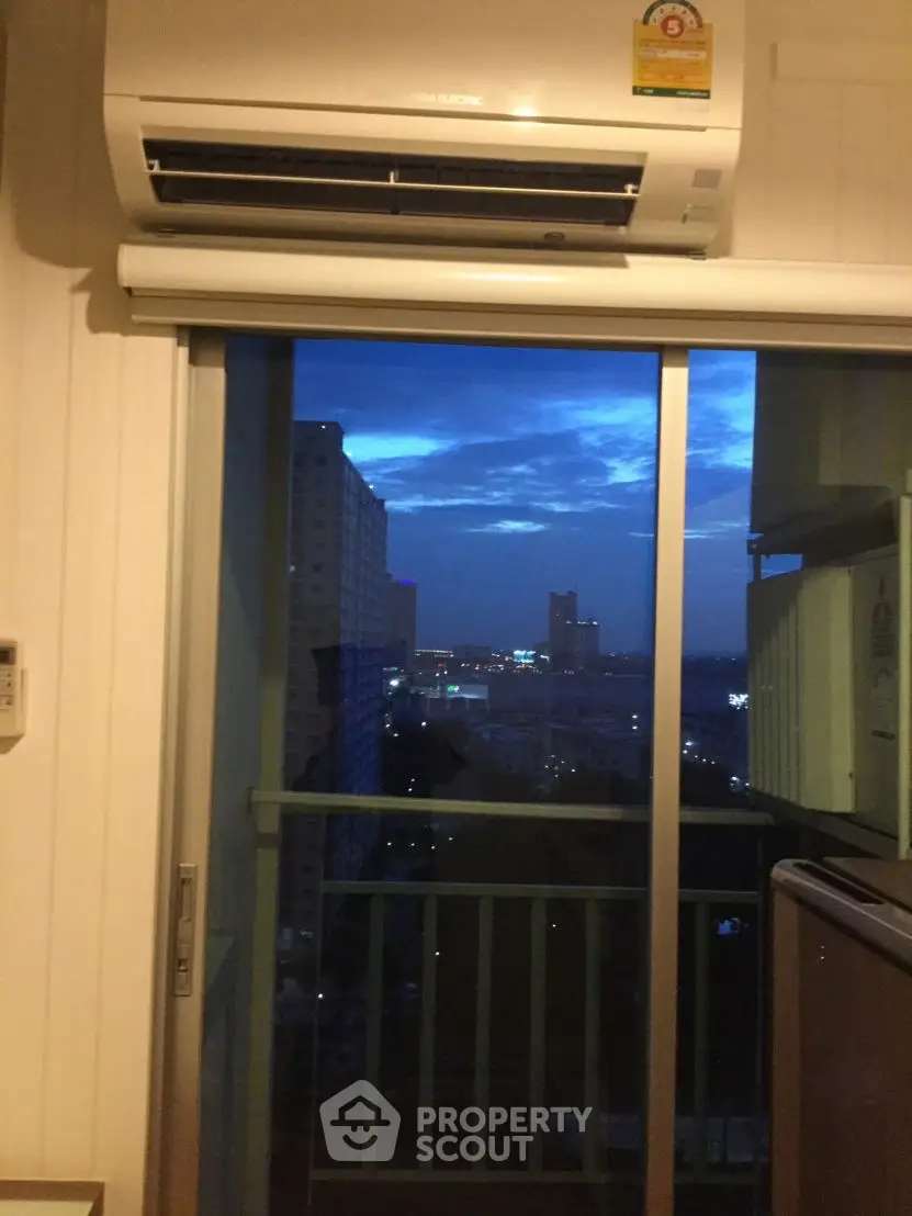 Modern apartment with city view from balcony at dusk