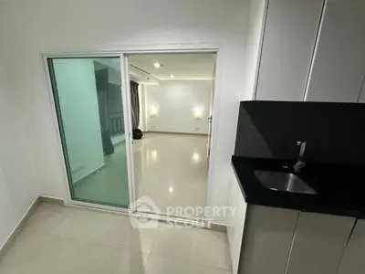 Modern interior with sliding glass doors and sleek kitchen area
