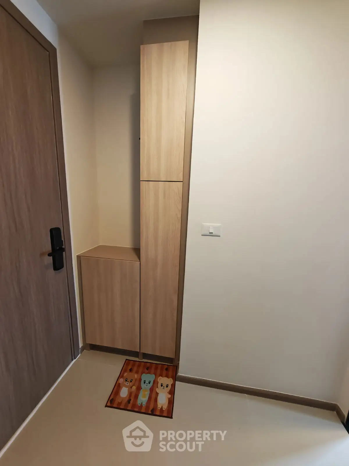 Modern entryway with sleek wooden cabinetry and stylish door mat