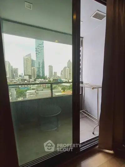 Modern apartment balcony with stunning city skyline view, perfect for urban living.