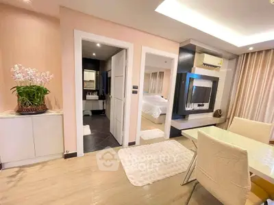 Modern open-plan living and dining area with elegant decor and bedroom view