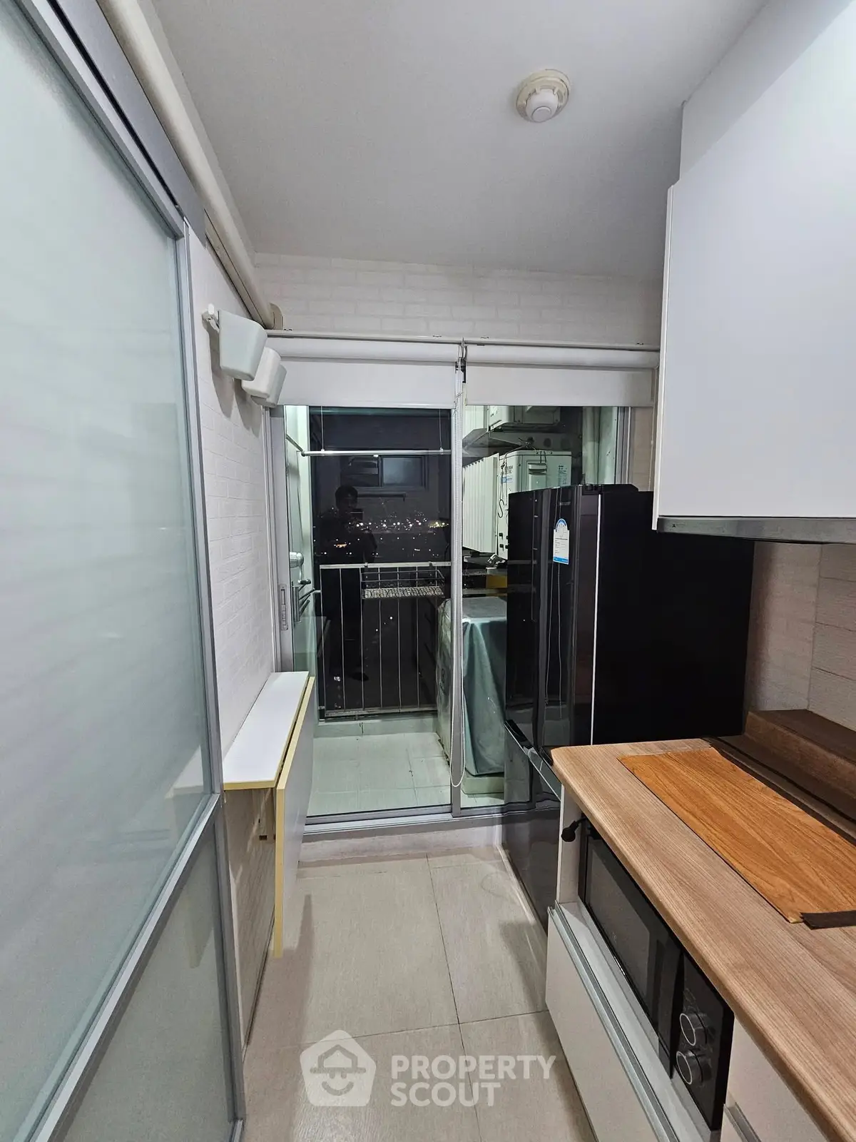 Modern kitchen with sleek appliances and balcony view