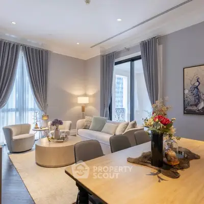 Luxurious living room with elegant decor and large windows in a modern apartment.