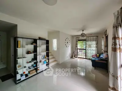 Spacious living room with modern decor and large windows for natural light