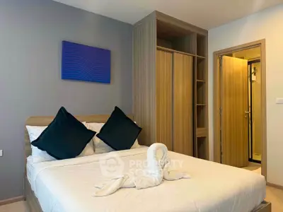 Modern bedroom with stylish decor and built-in wardrobe, perfect for a cozy retreat.