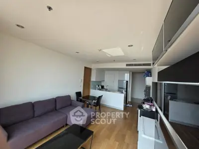 Modern living room with open kitchen and sleek furniture design