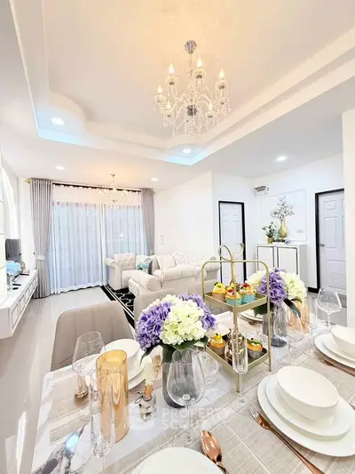 Luxurious open-plan living room with elegant dining setup and modern decor