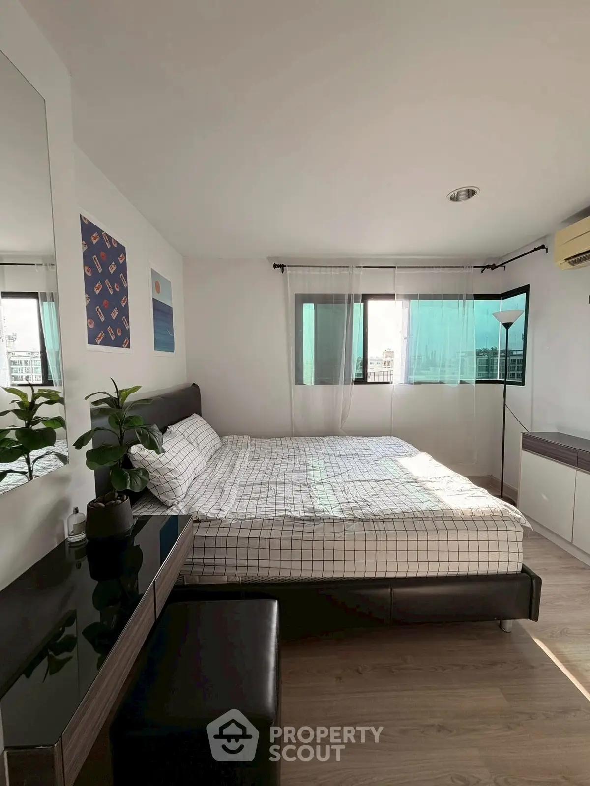 Bright and cozy bedroom with modern decor and large windows