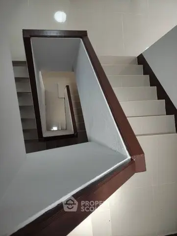 Modern staircase with sleek design and polished tiles in a contemporary building