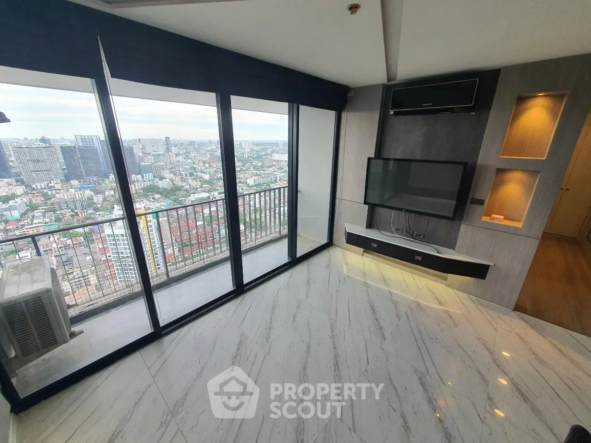 Luxurious high-rise living room with stunning city view and modern entertainment setup.