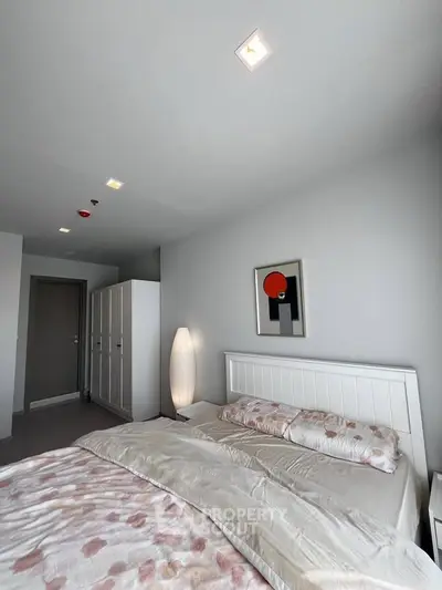 Modern bedroom with stylish decor and ample natural light