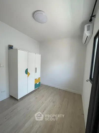 Minimalist bedroom with modern wardrobe and air conditioning unit
