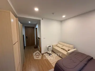 Cozy studio apartment with modern furnishings and wooden flooring