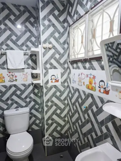 Charming bathroom with playful decor and modern fixtures