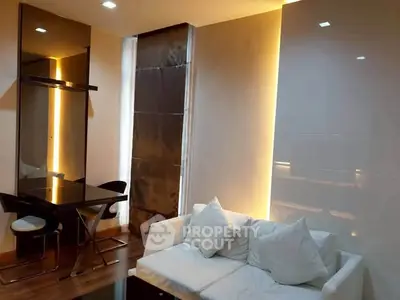 Modern living room with sleek design, featuring a cozy white sofa and stylish dining area.