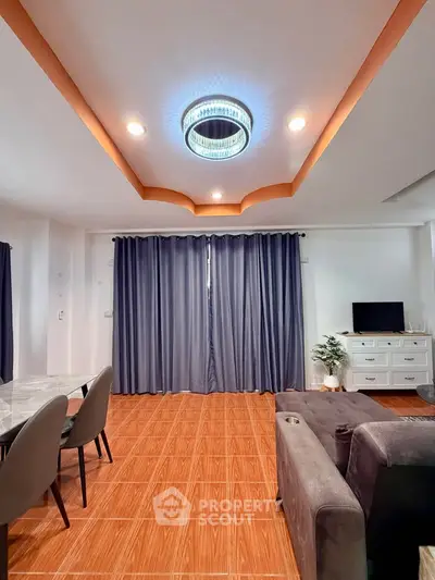 Spacious living room with elegant ceiling light and modern furniture