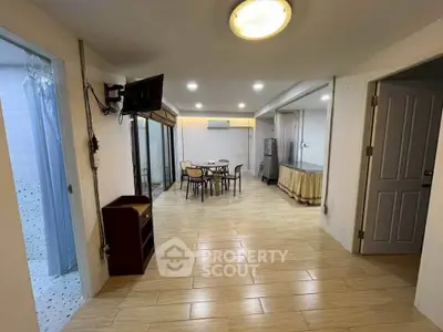 Spacious open-plan living area with modern furnishings and ample natural light.