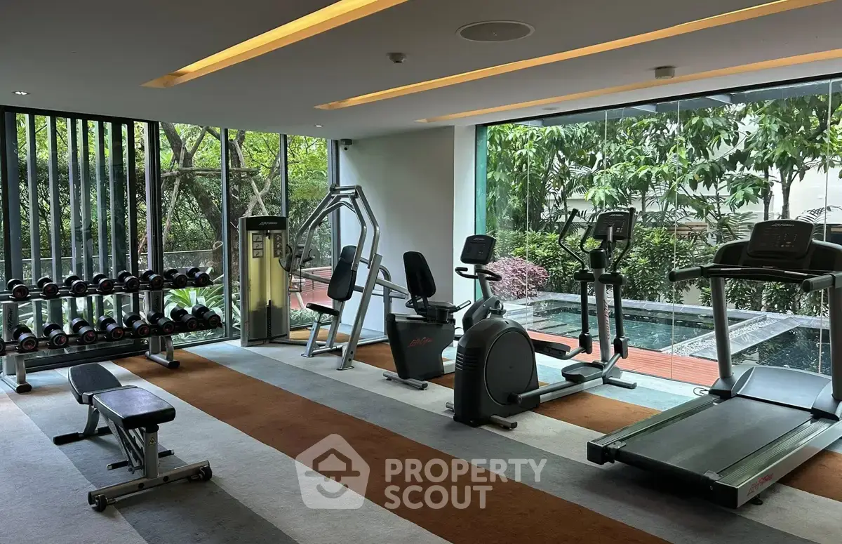 Modern gym with state-of-the-art equipment and lush garden view.