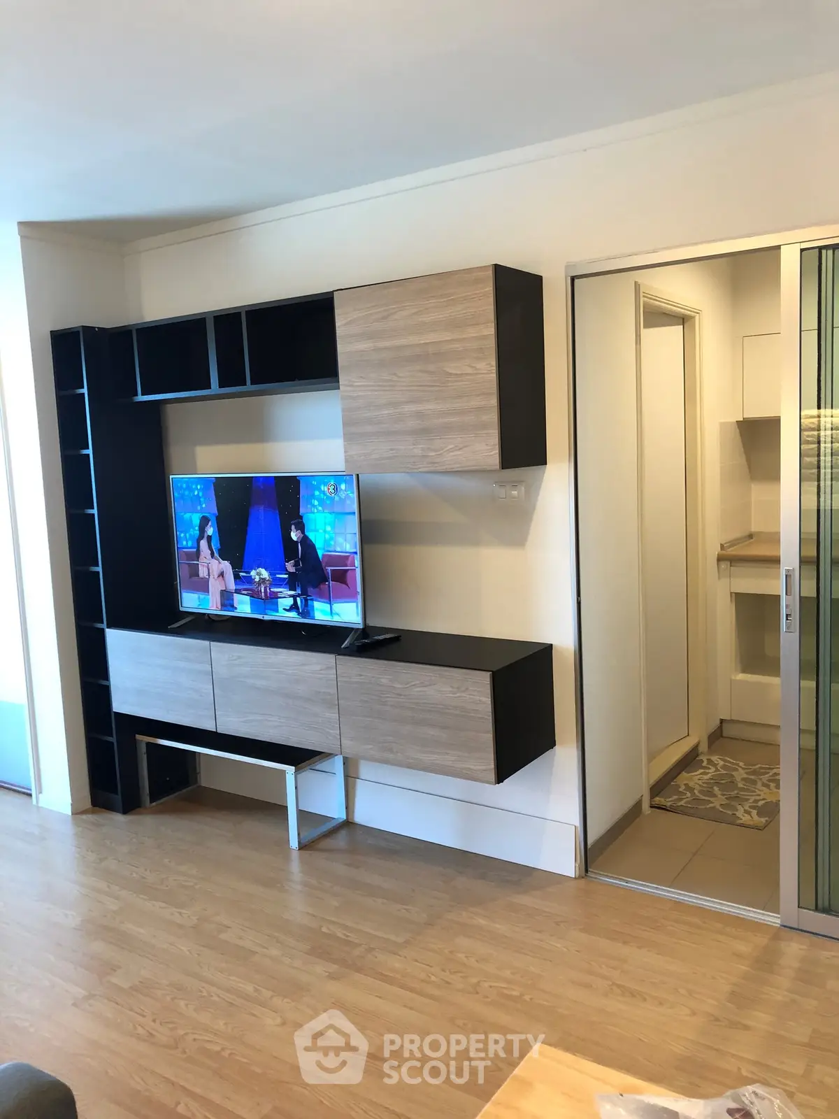 Modern living room with sleek entertainment unit and wooden flooring