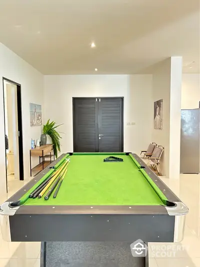 Stylish game room with pool table and modern decor in luxury home