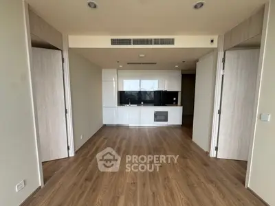 Modern open-plan living area with sleek kitchen and wooden flooring