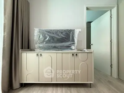 Modern interior with stylish cabinet and wrapped TV in a contemporary living space.