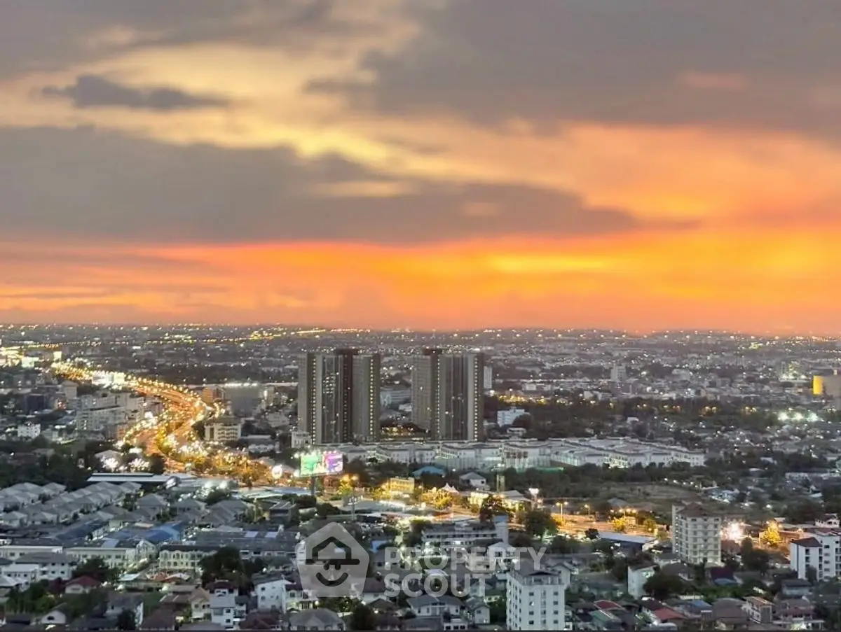 Stunning cityscape view with vibrant sunset over urban skyline.