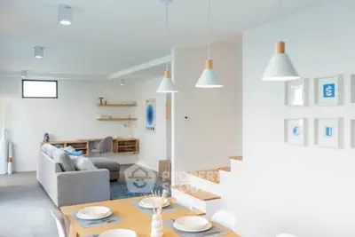 Modern open-plan living and dining area with stylish decor and ample natural light.