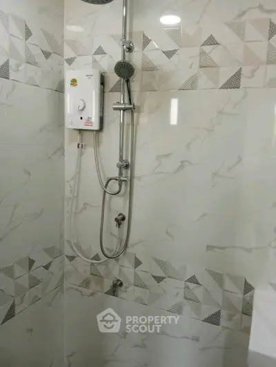 Modern bathroom with stylish shower and geometric tile design