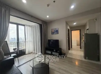 Spacious living room with large windows and city view, modern furnishings, and open layout.