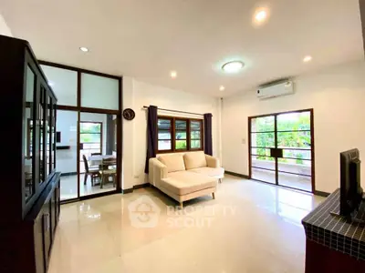 Spacious living room with large windows and modern decor