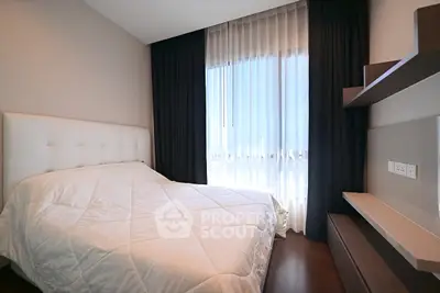 Modern bedroom with elegant design, featuring a cozy bed and stylish shelving, perfect for relaxation.